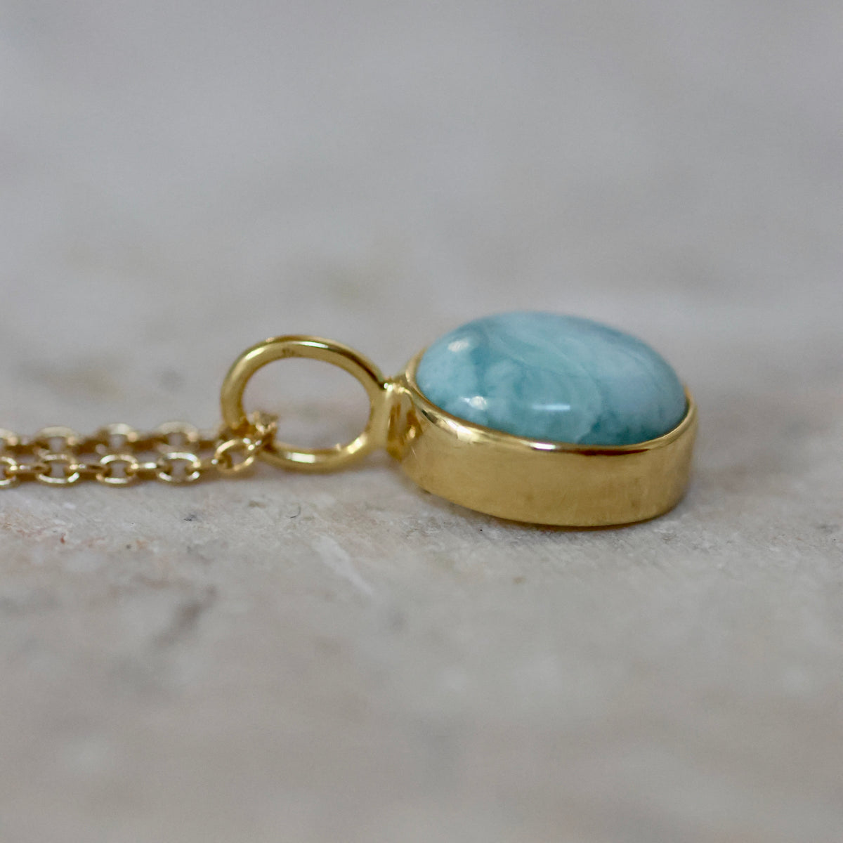 Larimar oval necklace gold be Soulshine Gems, on cable chain 42cm, side view.