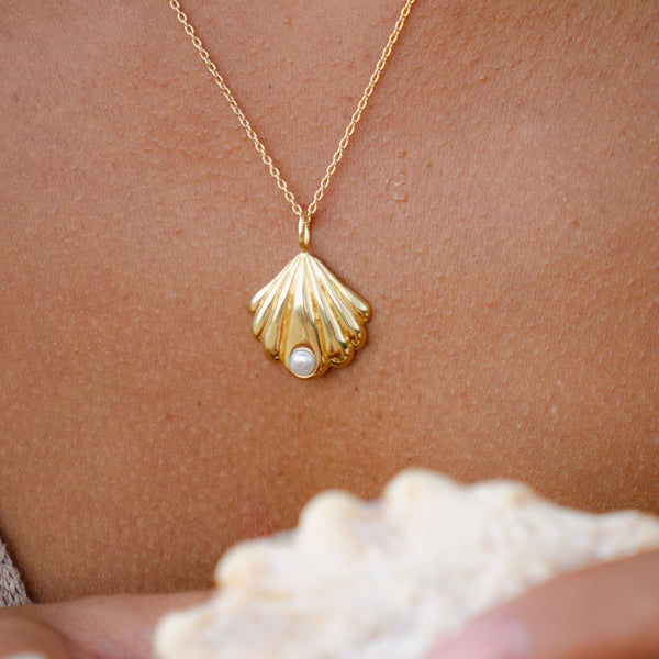 Gold shell pendant necklace with little 6mm size freshwater pearl. Elegant island style jewelry. Made by local artisans in Bali.
