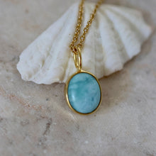 Load image into Gallery viewer, Larimar gold pendant necklace on a gold chain with a shell in the background. 
